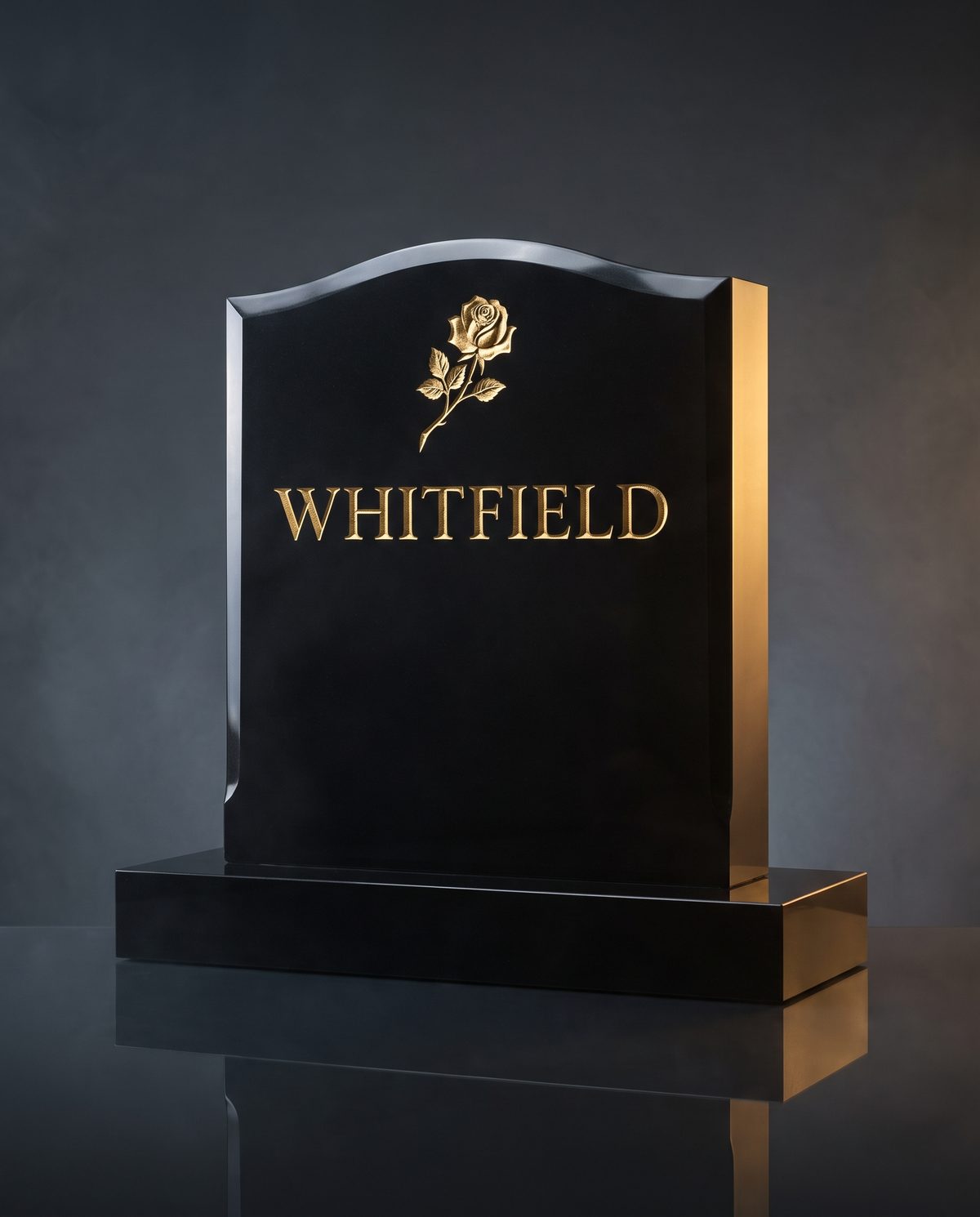 Jet-black granite upright headstone with gold leaf lettering and carved rose